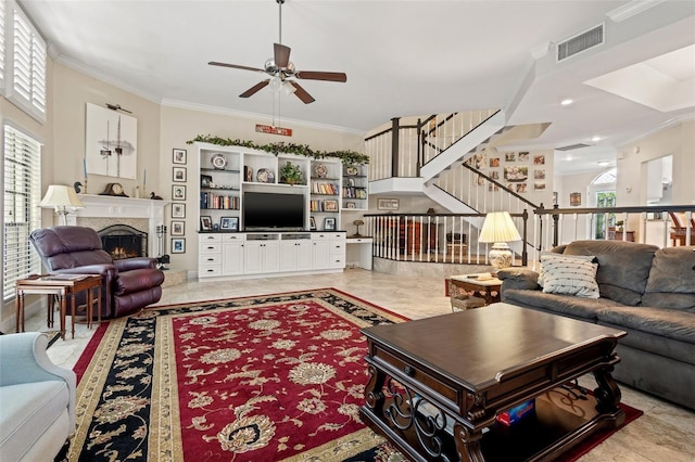 living room with ceiling fan and ornamental molding