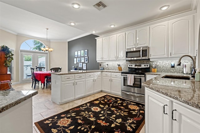 kitchen with kitchen peninsula, sink, white cabinets, and stainless steel appliances