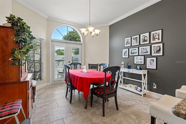 dining room with a notable chandelier, crown molding, and french doors