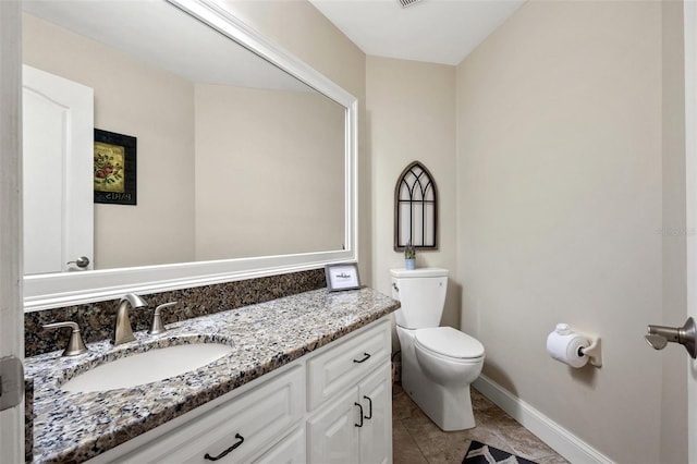 bathroom featuring tile patterned floors, vanity, and toilet