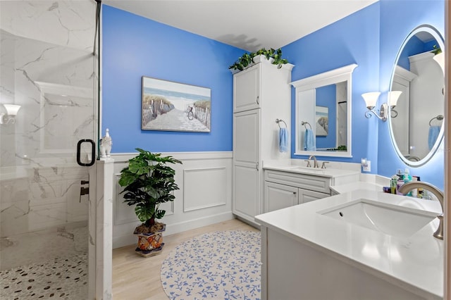 bathroom featuring wood-type flooring, vanity, and an enclosed shower