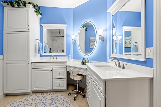 bathroom featuring wood-type flooring, vanity, and walk in shower