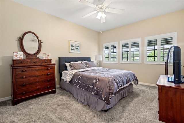 carpeted bedroom with ceiling fan and multiple windows