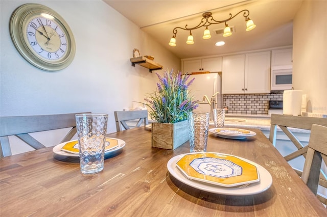 dining space with light hardwood / wood-style flooring