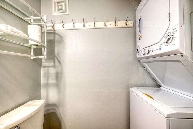 laundry room with stacked washer and dryer