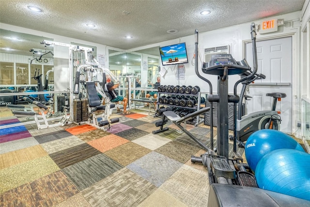 exercise room featuring a textured ceiling