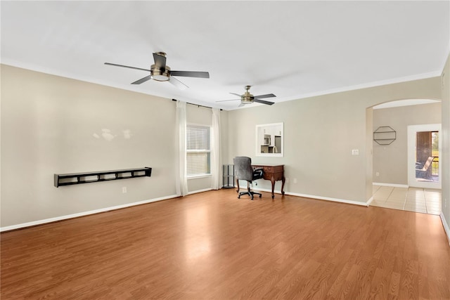 interior space with ceiling fan, light hardwood / wood-style flooring, and ornamental molding