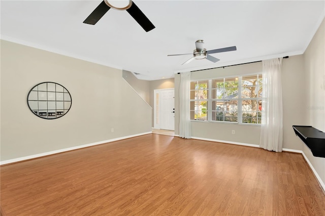 unfurnished living room with ceiling fan, ornamental molding, and light hardwood / wood-style flooring