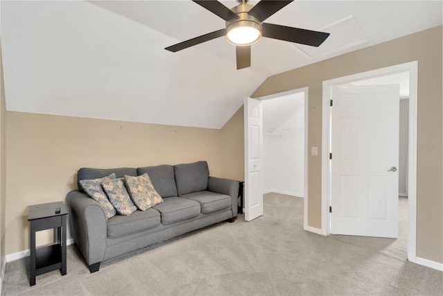 carpeted living room featuring ceiling fan and vaulted ceiling