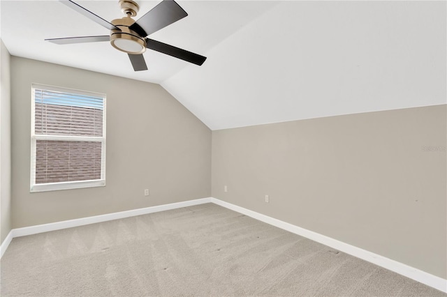 additional living space featuring ceiling fan, light colored carpet, and vaulted ceiling