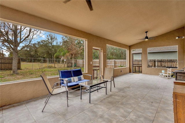 sunroom / solarium with ceiling fan and lofted ceiling