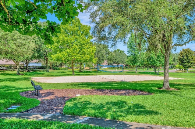 view of property's community featuring volleyball court and a yard