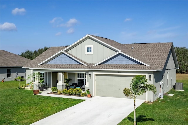 view of front of house featuring central air condition unit, a garage, a porch, and a front yard