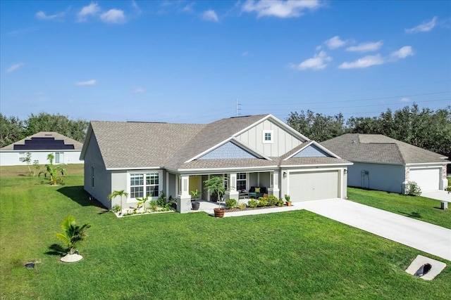 view of front facade featuring a front yard, a garage, and a porch