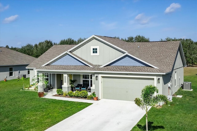 view of front facade with a front lawn, central air condition unit, a porch, and a garage