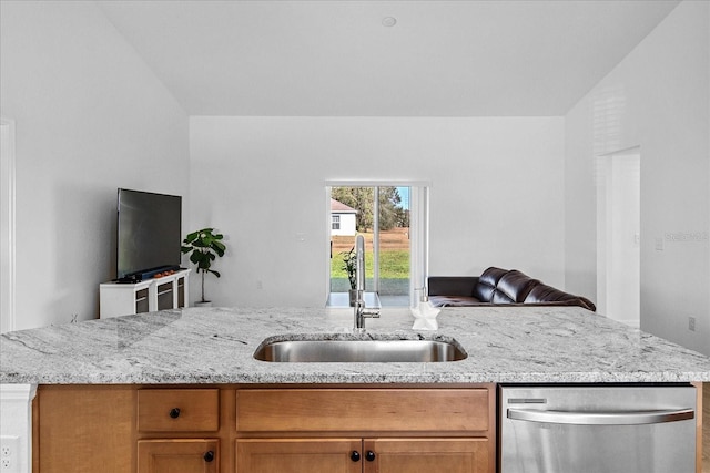 kitchen featuring light stone counters, sink, and stainless steel dishwasher