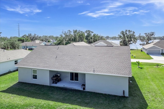 back of house with a patio and a yard