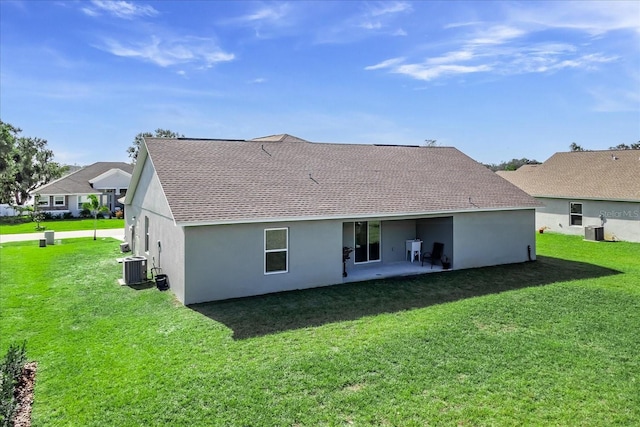 back of house featuring a lawn, central AC, and a patio