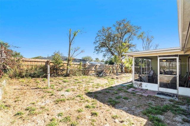 view of yard with a playground and a sunroom