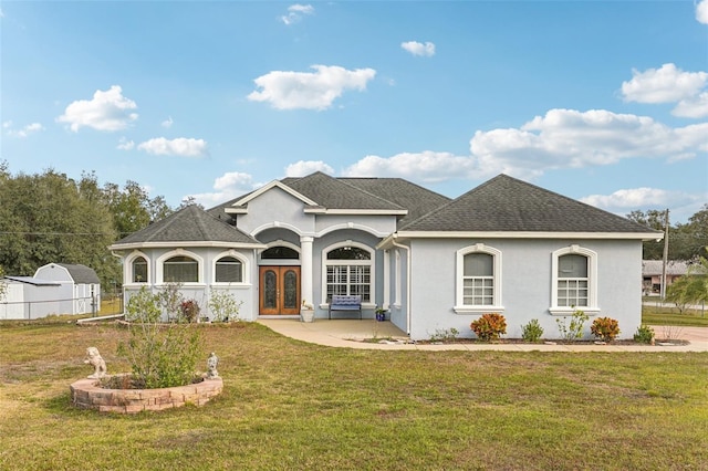 view of front facade with french doors and a front lawn