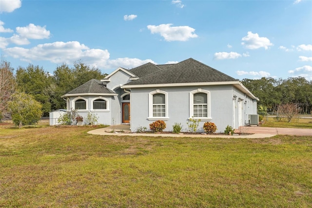 view of front of home with central air condition unit and a front yard