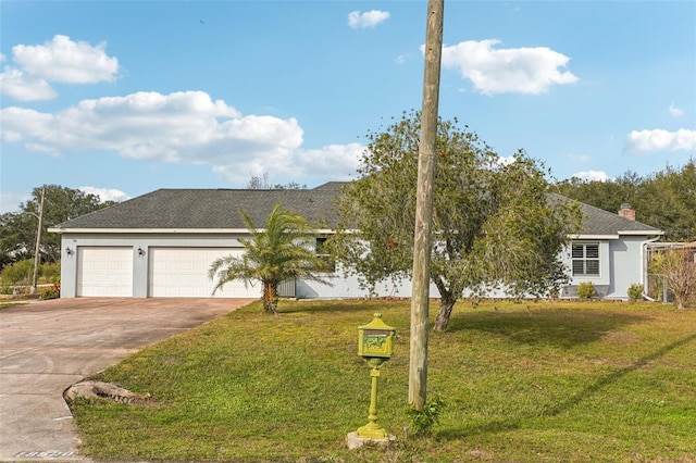 single story home with a garage and a front lawn