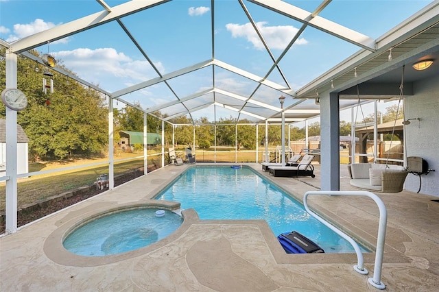 view of swimming pool with an in ground hot tub, a patio, and a lanai