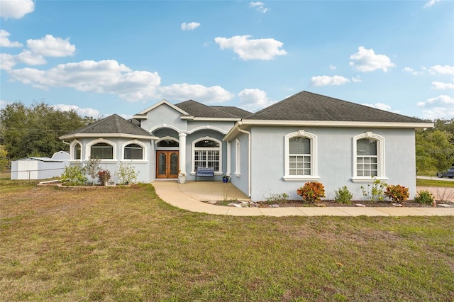 view of front of home with french doors and a front yard