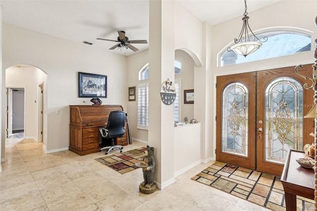 foyer with french doors, a wealth of natural light, and ceiling fan