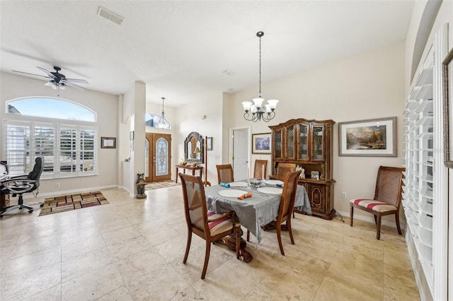 dining space featuring ceiling fan with notable chandelier