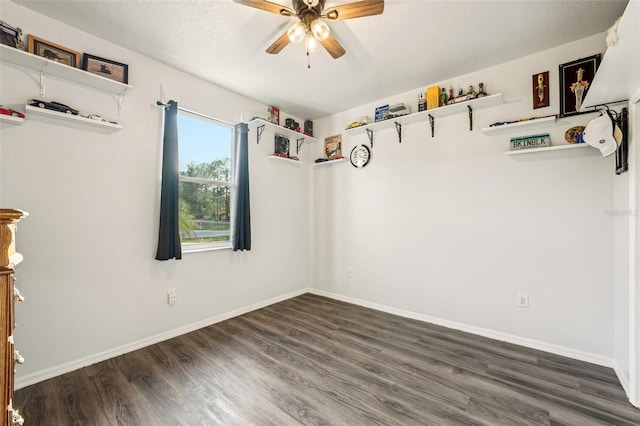 unfurnished room featuring ceiling fan and dark wood-type flooring