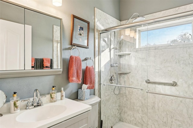 bathroom featuring vanity and an enclosed shower