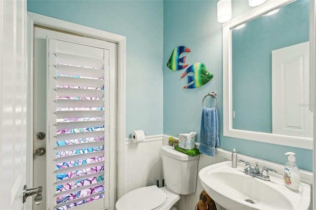 bathroom featuring toilet and sink