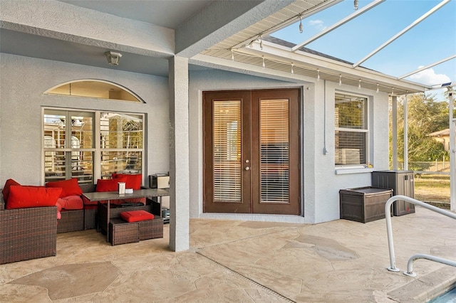 view of exterior entry featuring a patio area and french doors