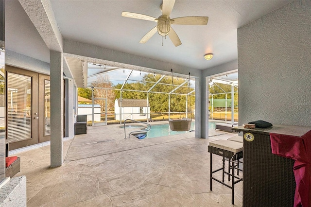 view of patio featuring french doors, a fenced in pool, glass enclosure, and ceiling fan