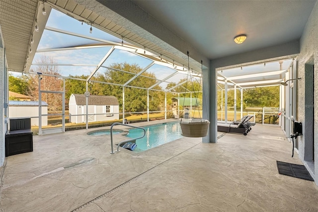 view of pool featuring a patio, a shed, an outdoor hangout area, and a lanai