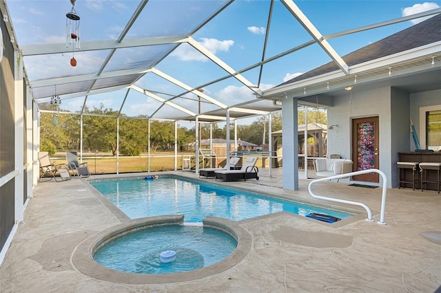 view of swimming pool featuring a lanai, an in ground hot tub, and a patio