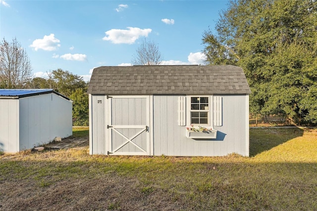 view of outbuilding with a yard