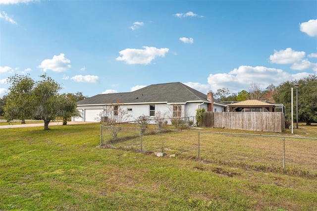 exterior space featuring a yard and a garage