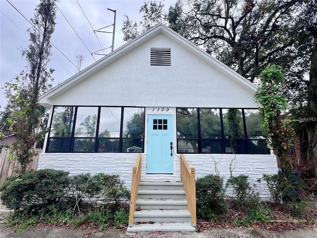 view of front of house featuring a sunroom