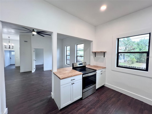 kitchen with wooden counters, white cabinets, electric stove, hanging light fixtures, and dark hardwood / wood-style floors