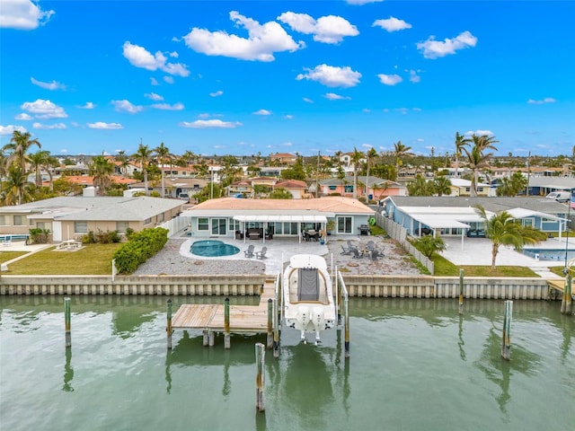 back of property with a water view