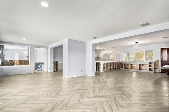 unfurnished living room featuring light parquet flooring