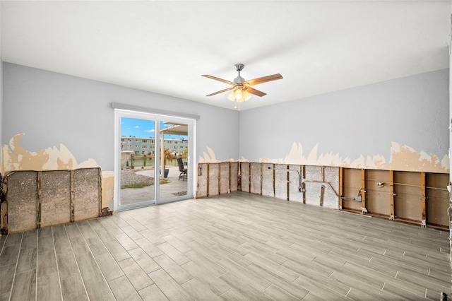 spare room featuring ceiling fan and light hardwood / wood-style floors