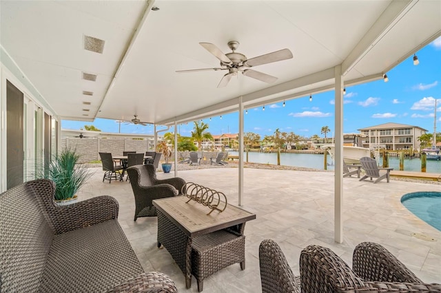 view of patio / terrace featuring a water view and ceiling fan