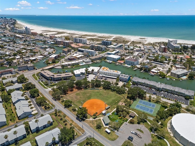 birds eye view of property with a water view and a view of the beach