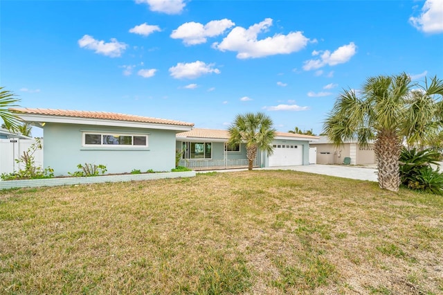 view of front of home featuring a garage and a front lawn