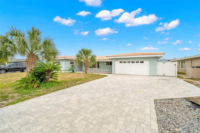 single story home featuring a front yard and a garage