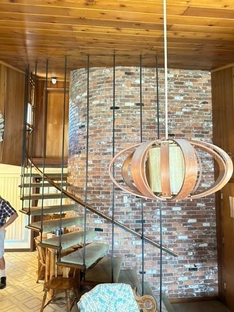 stairway featuring wood ceiling and wooden walls