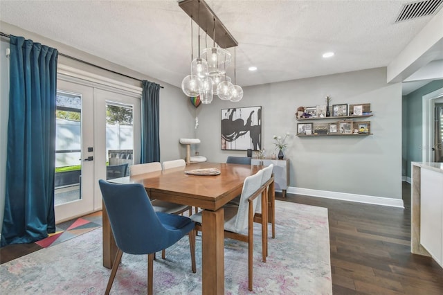 dining room featuring dark hardwood / wood-style floors, a textured ceiling, and french doors